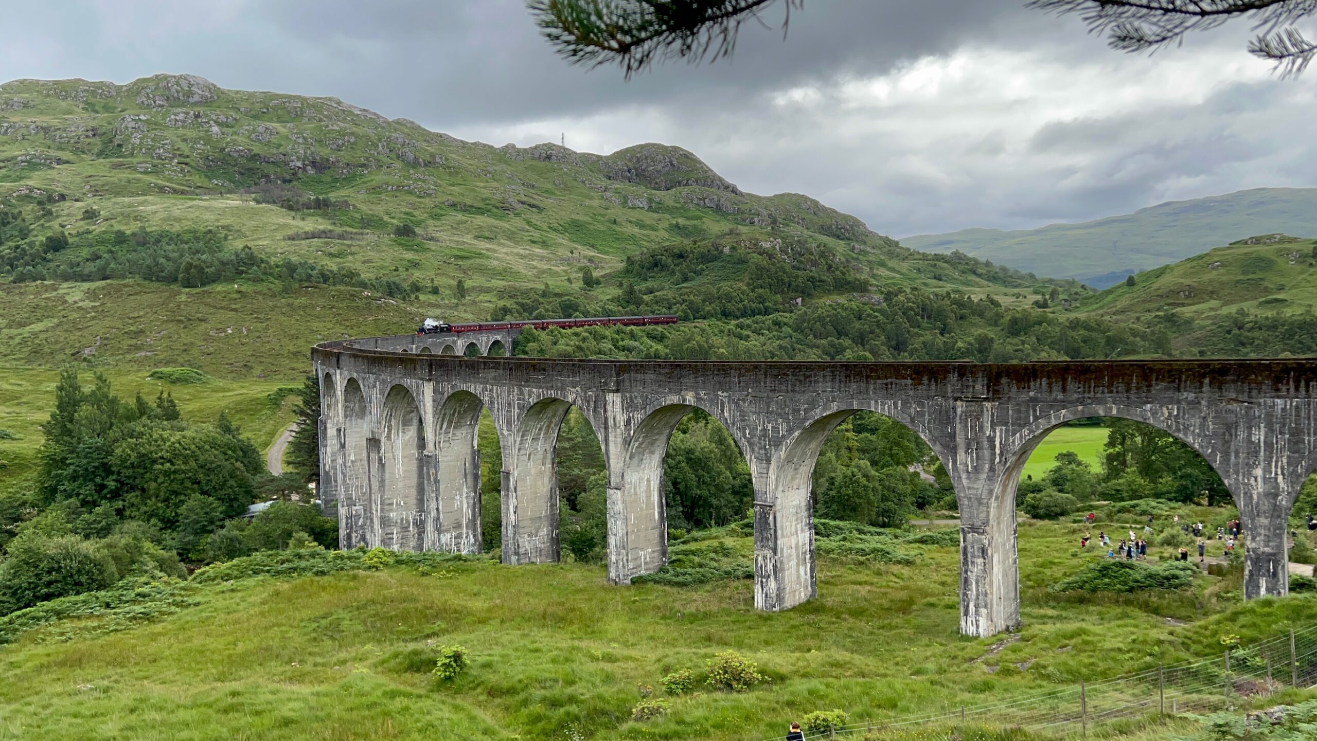 The Harry Potter Bridge in Scotland. On the bridge is the Jacobite train riding.